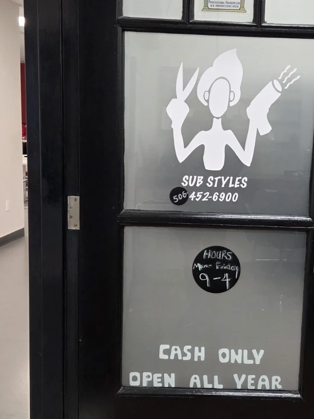 The SUB Styles logo and posted hours, cash-only and open-all-year notices on the salon door.