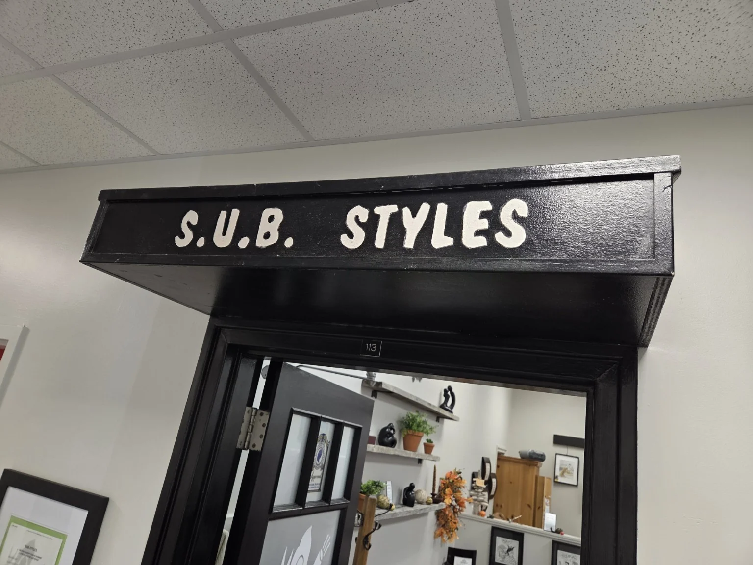 The SUB Styles sign above the entrance to salon Room 113.