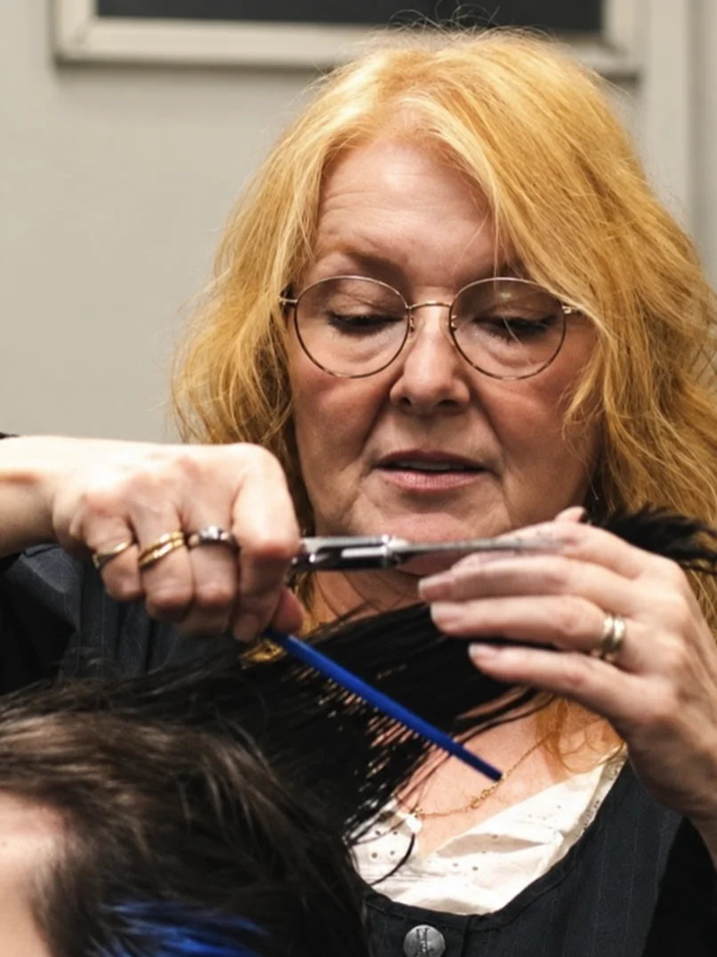 Vicki trimming a client's hair at SUB Styles.